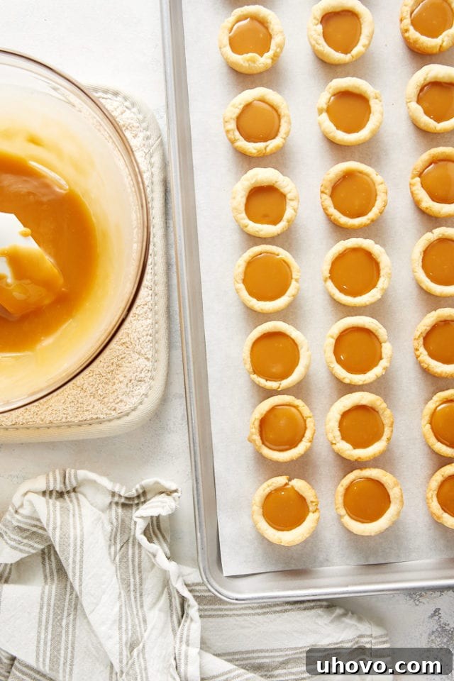 Overhead view of mini tarts filled with a caramel filling