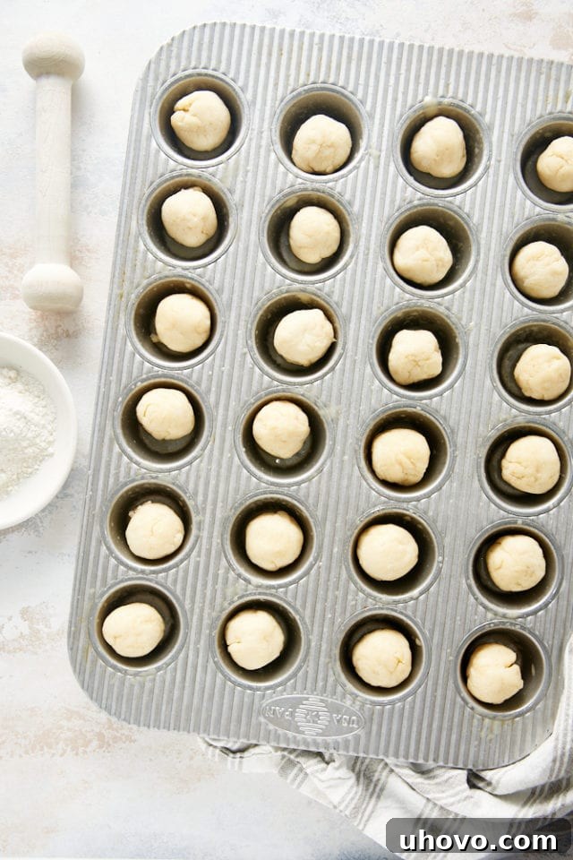 Balls of cream cheese pie dough in a mini muffin pan