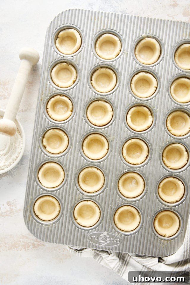 Cream cheese pie crusts shaped in a mini muffin pan