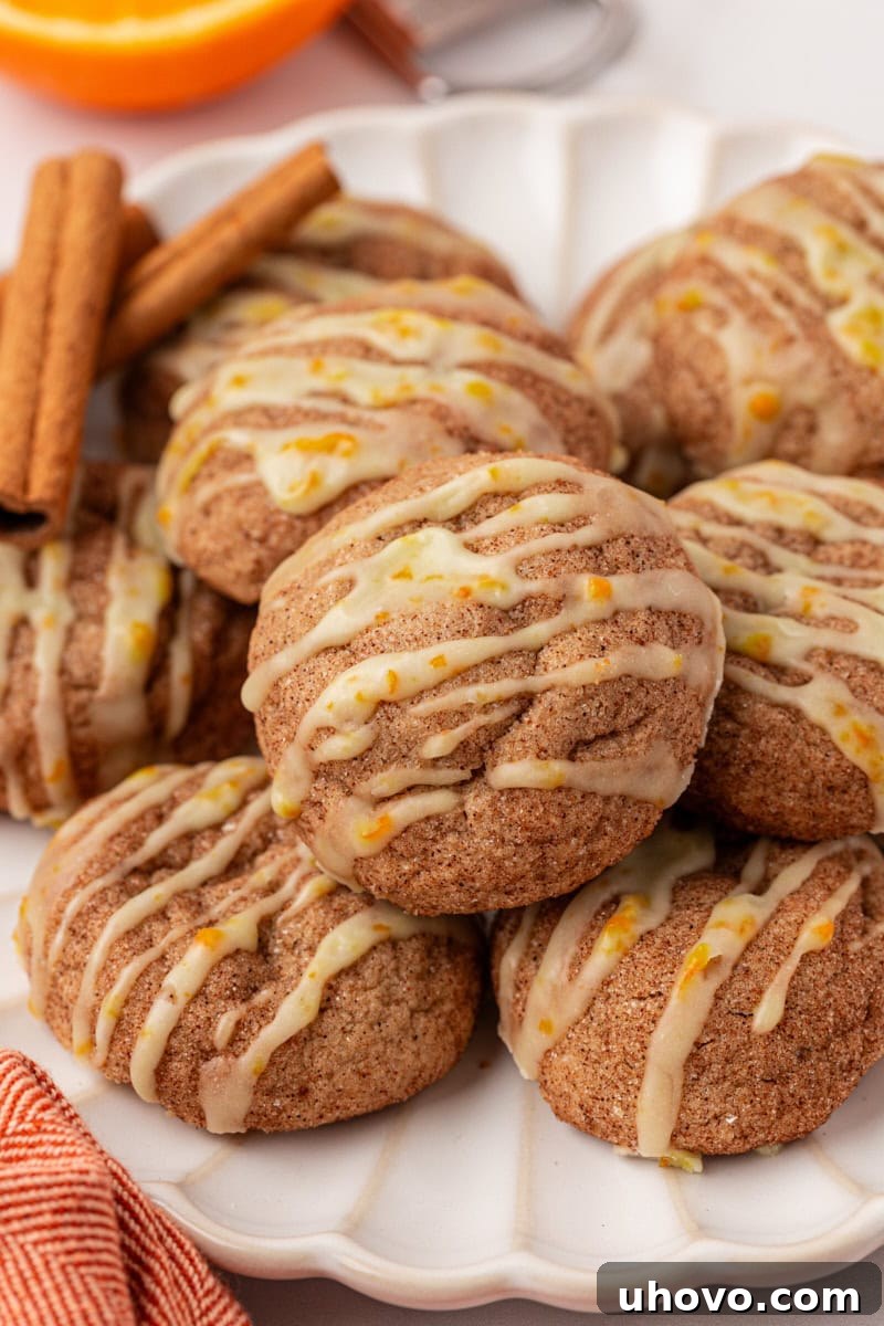 sugar and spice cookies topped with orange glaze on a white plate