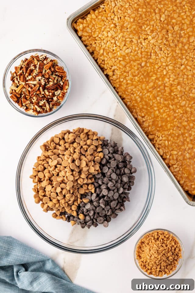 Overhead view of a glass mixing bowl containing both semisweet chocolate chips and peanut butter baking chips, ready for melting.