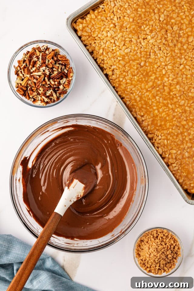 Melted chocolate and peanut butter baking chips in a glass mixing bowl, stirred until smooth and glossy.