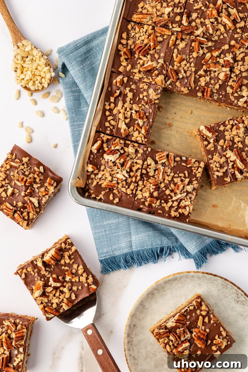 An appetizing overhead view of several chocolate peanut butter cereal bars, some still in the pan, some on a wooden cutting board, and a few artfully arranged on a white plate.