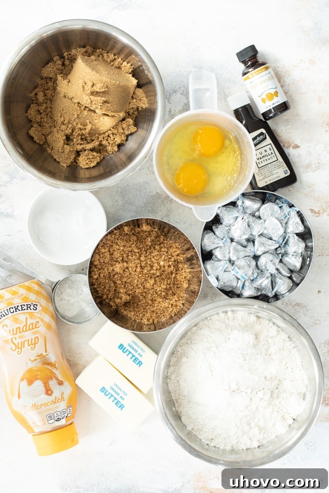Neatly arranged ingredients for Chocolate Caramel Kiss Cookies, including flour, sugars, butter, and Hershey's Kisses, ready for baking.