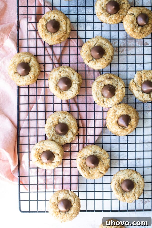 Freshly baked Chocolate Caramel Kiss Cookies cooling on a wire rack, with their iconic chocolate kisses nestled in the center.
