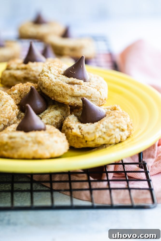 A close-up shot of several Chocolate Caramel Kiss Cookies beautifully arranged on a bright yellow plate, showcasing their inviting texture.