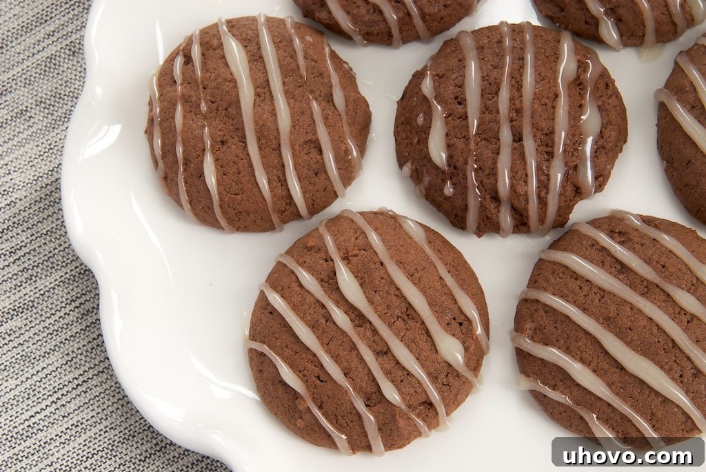 Soft and chewy Hot Chocolate Cookies topped with a sweet Marshmallow Glaze, perfect for holiday baking and festive treat platters.