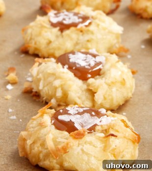Coconut-Salted Caramel Thumbprint Cookies on parchment paper