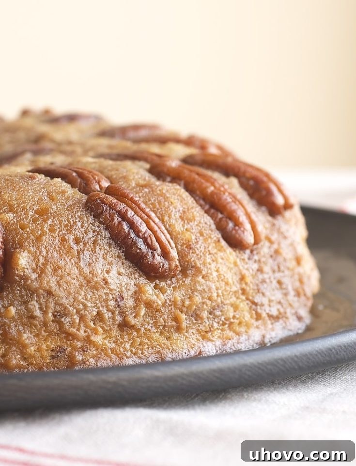 Close-up of a slice of Pecan Upside-Down Cake, showcasing the caramelized pecan topping and moist cake texture.