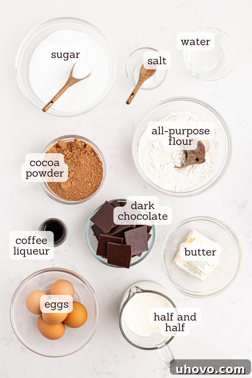 overhead view of all the simple ingredients laid out for making hot fudge pie, including chocolate, butter, eggs, and flour