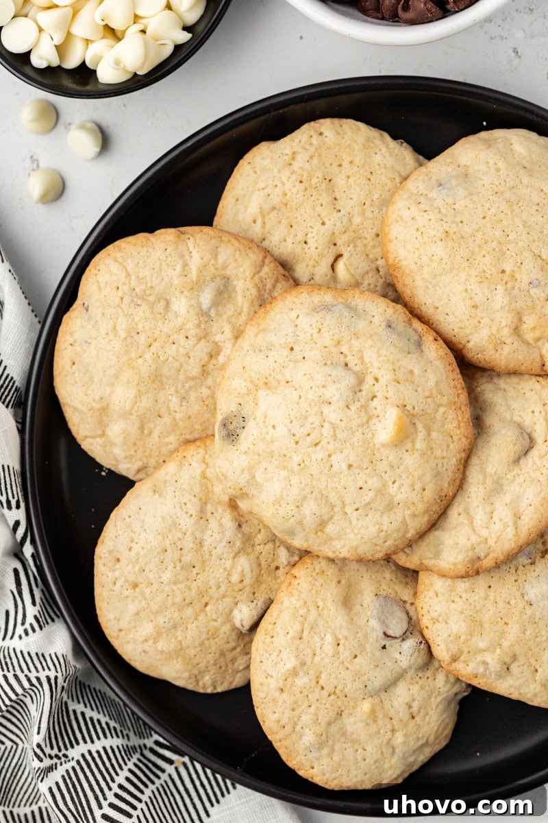 Overhead view of black and white chocolate chip cookies on plate