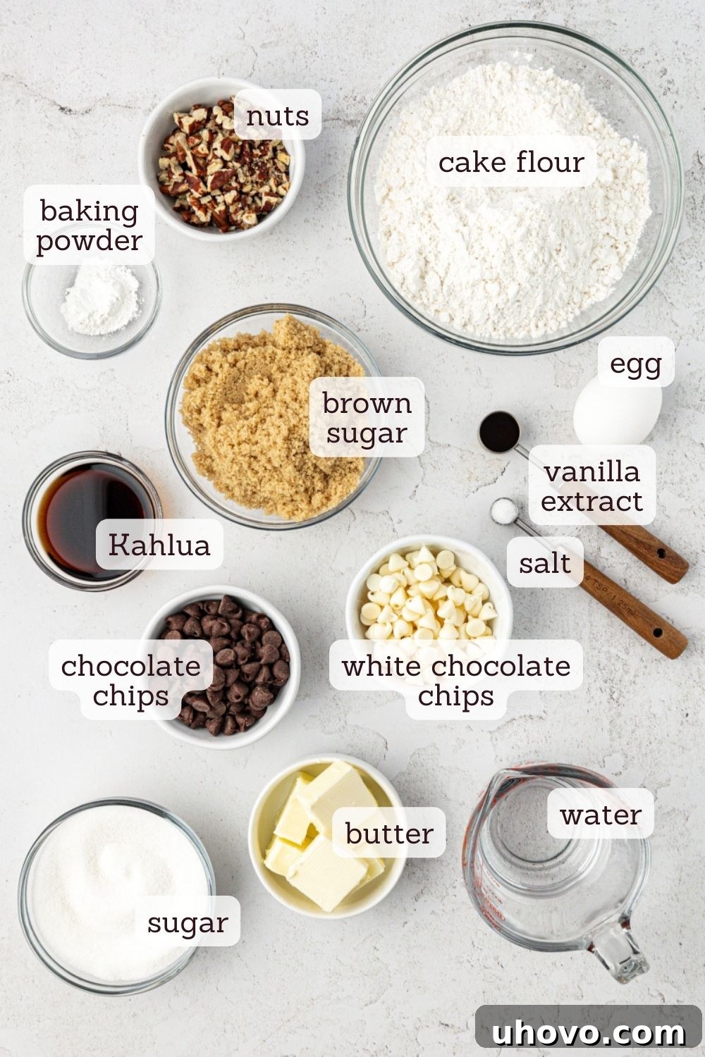 Overhead view of ingredients for black and white chocolate chip cookies with labels
