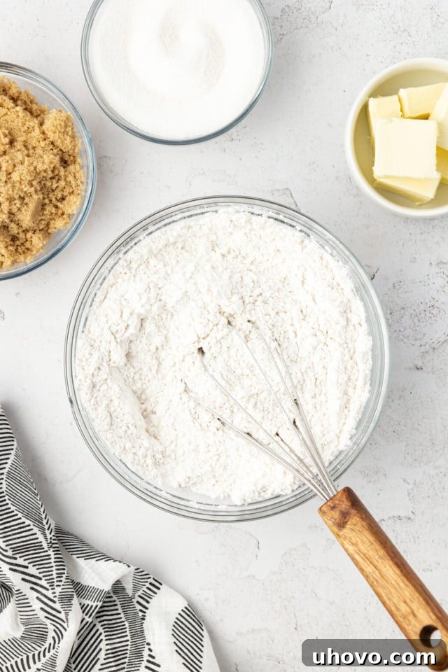 Overhead view of dry ingredients in bowl with whisk