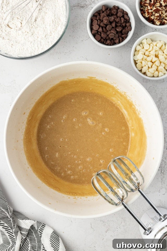Overhead view of wet ingredients for cookies in mixing bowl