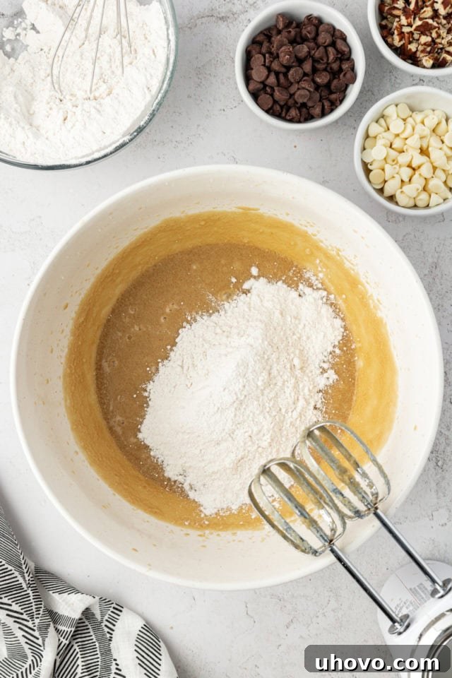 Overhead view of dry ingredients added to wet ingredients for cookies