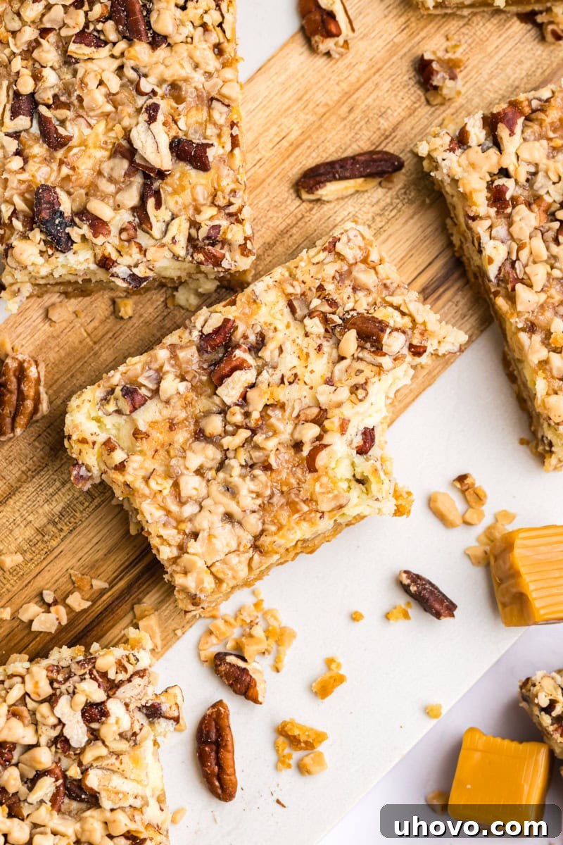 overhead view of caramel cheesecake bars on a wooden cutting board