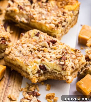 close-up of a caramel cheesecake bar showing gooey caramel layer