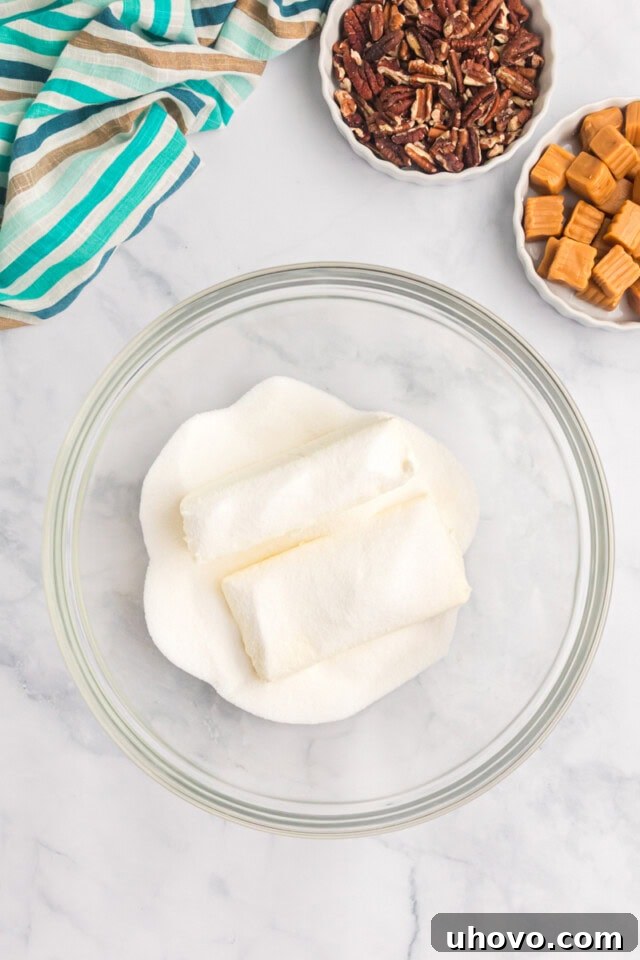 overhead view of cream cheese and sugar in a mixing bowl
