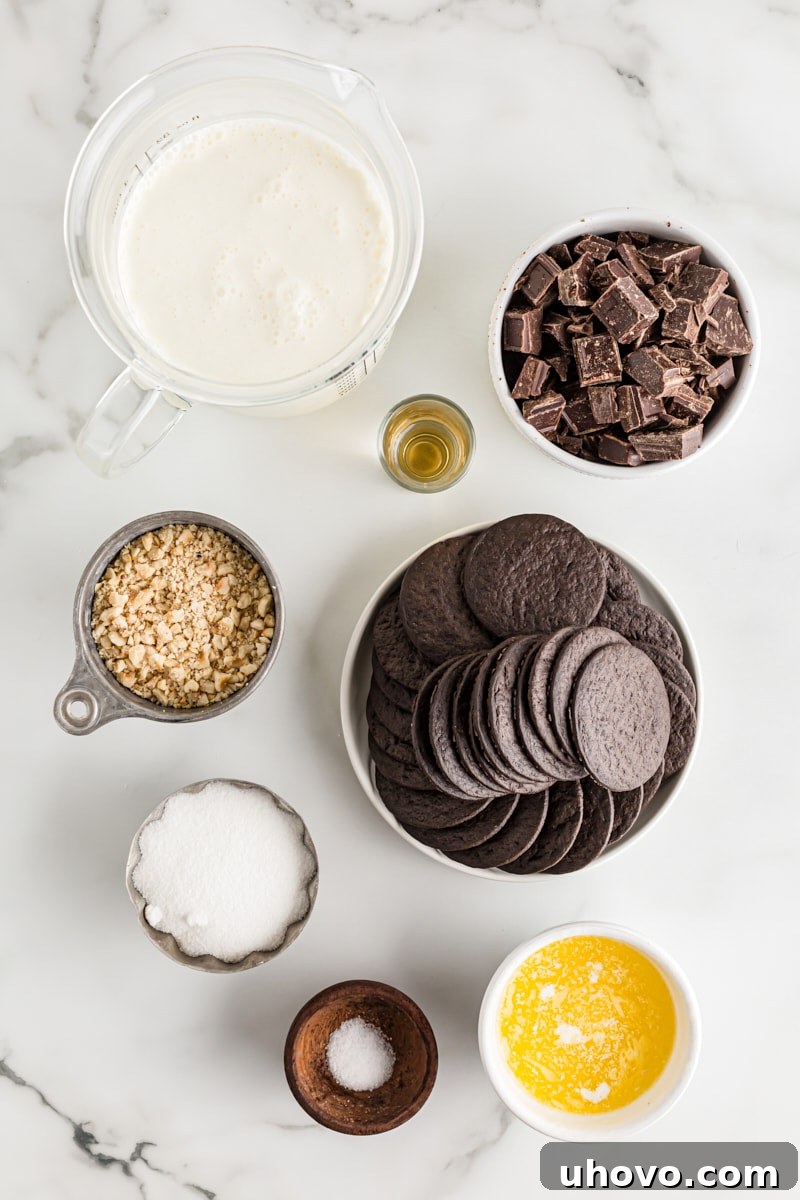 An overhead view of the essential ingredients for Chocolate Hazelnut Black-Bottom Pie neatly arranged, including chocolate wafers, heavy cream, chocolate chunks, and hazelnuts, ready for preparation.