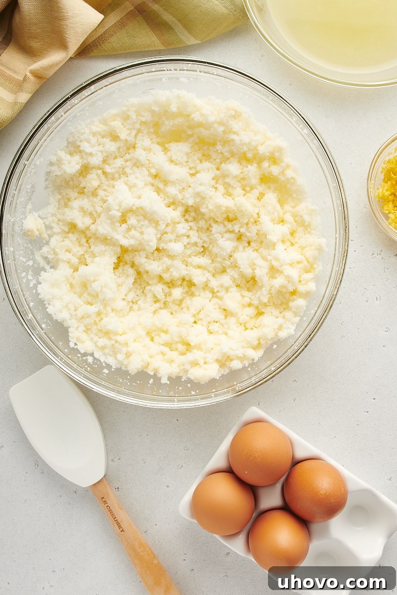 overhead view of butter and sugar mixed in a glass mixing bowl