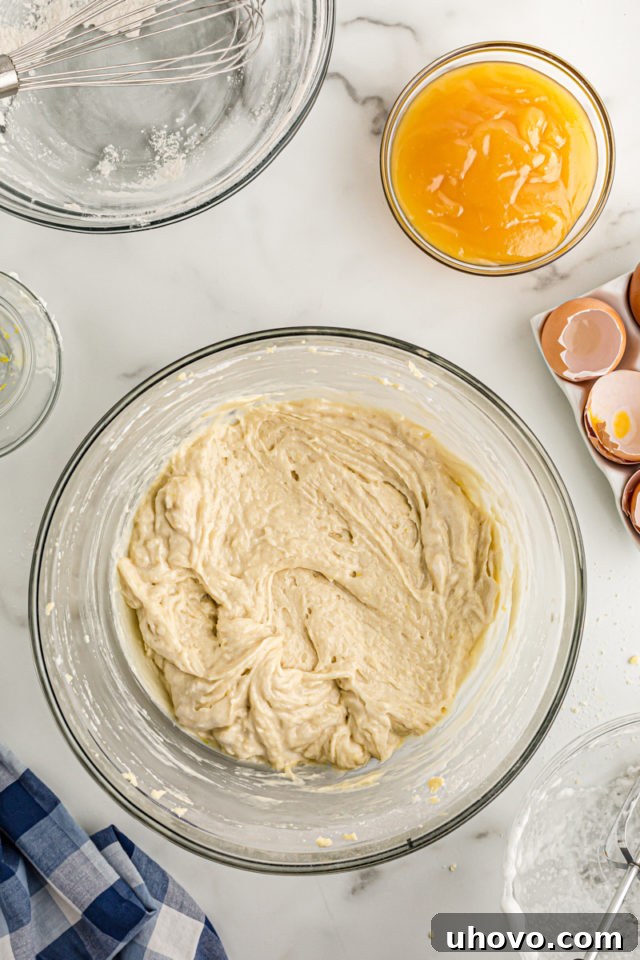 Overhead view of cake batter and lemon curd in glass bowls