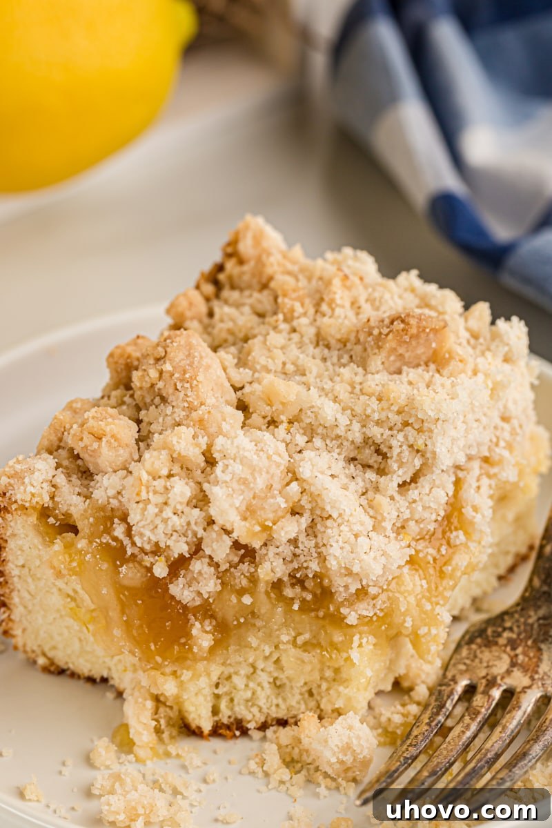 Piece of lemon yogurt crumb cake on plate with fork
