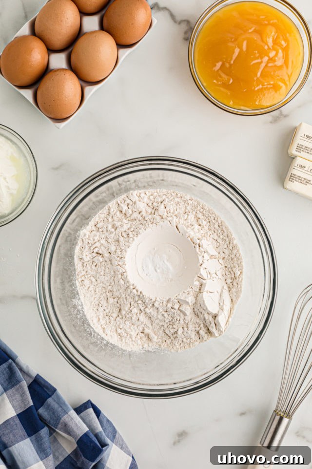Overhead view of dry cake ingredients in glass bowl