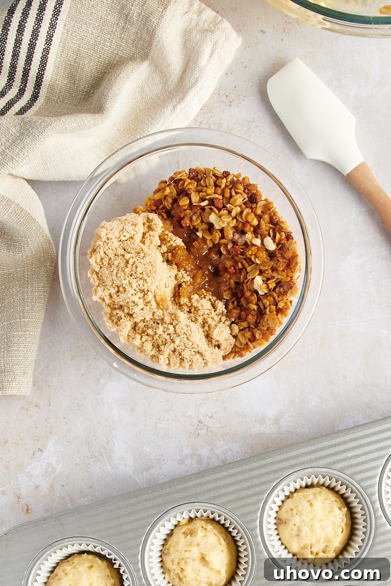 An overhead shot of granola streusel ingredients, including brown sugar and butter, in a small bowl before mixing.