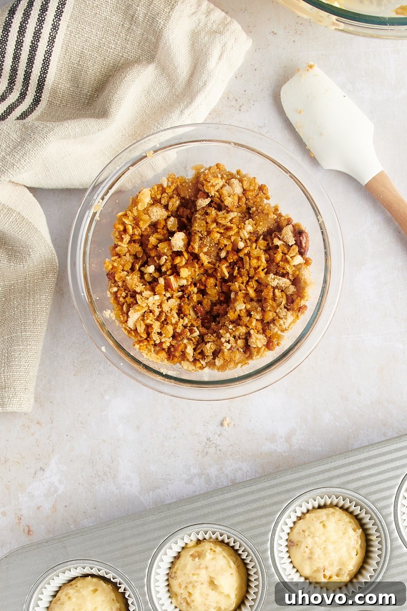 Overhead view of the prepared granola streusel, perfectly crumbly, in a small bowl.