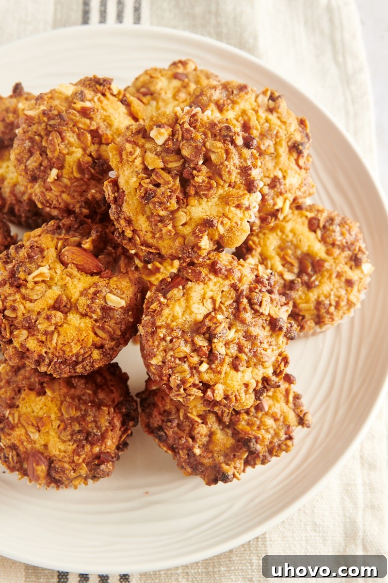 An enticing overhead shot of granola yogurt muffins stacked neatly on a white platter, ready to be served.