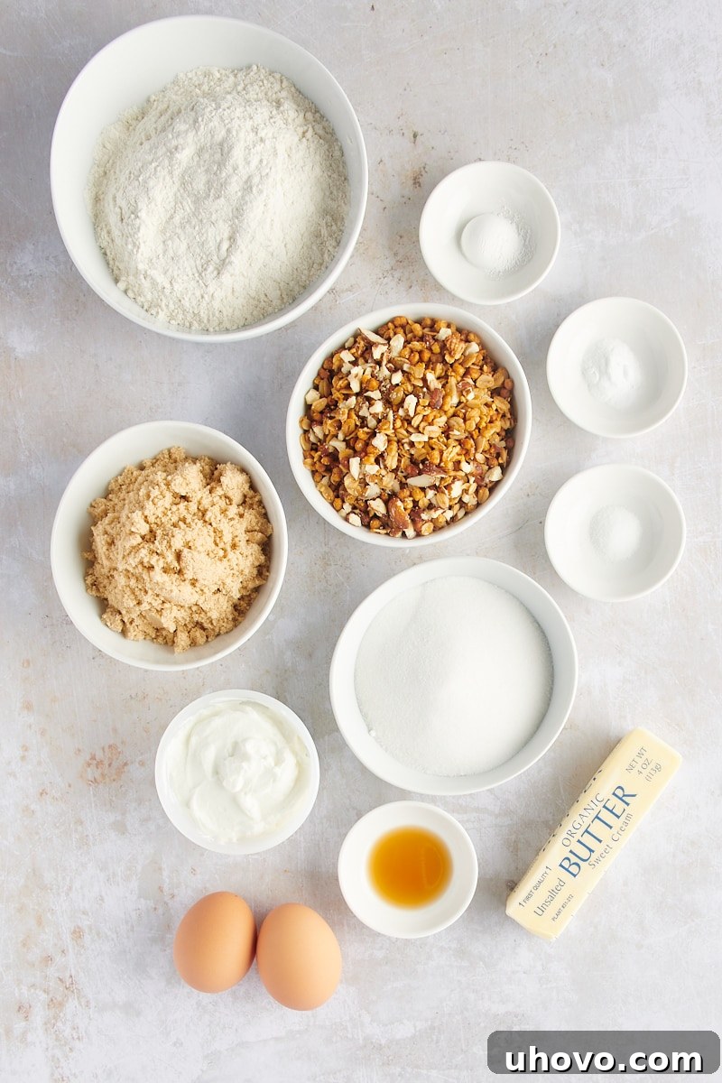 An overhead shot showcasing all the fresh ingredients neatly arranged for making granola yogurt muffins.