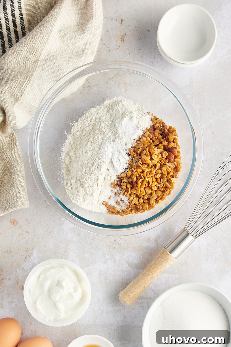 An overhead view of the dry muffin ingredients perfectly measured and placed in a mixing bowl, ready for whisking.