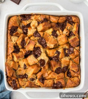 Overhead view of chocolate croissant bread pudding in square baking dish, freshly baked