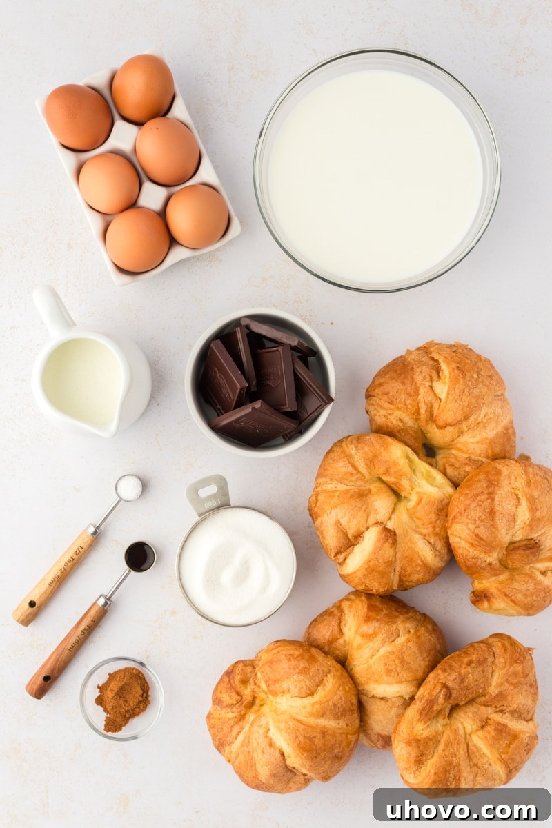 Overhead view of all ingredients for chocolate croissant bread pudding laid out on a counter
