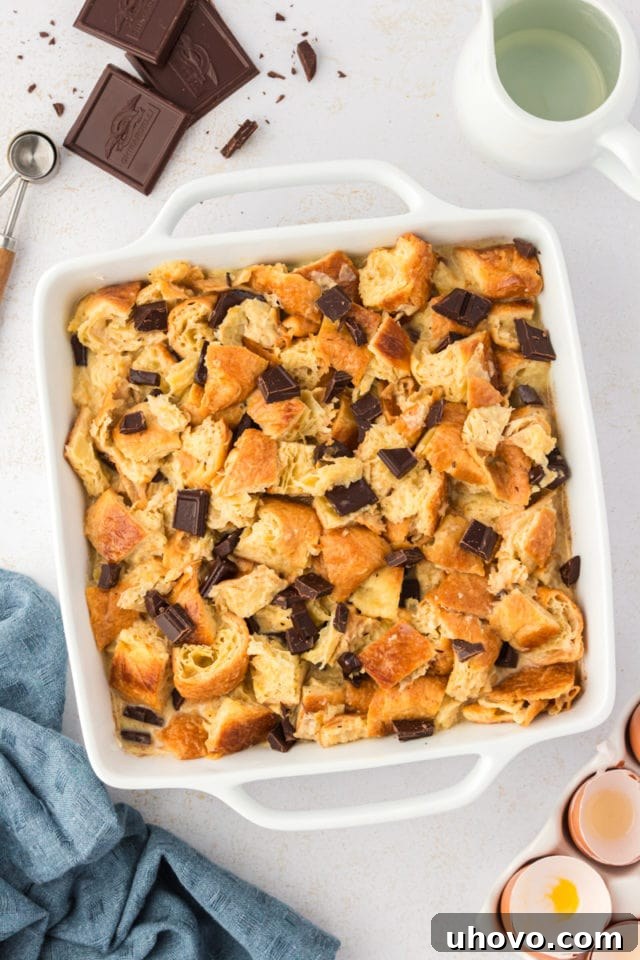 Overhead view of chocolate croissant bread pudding mixture in baking dish before baking