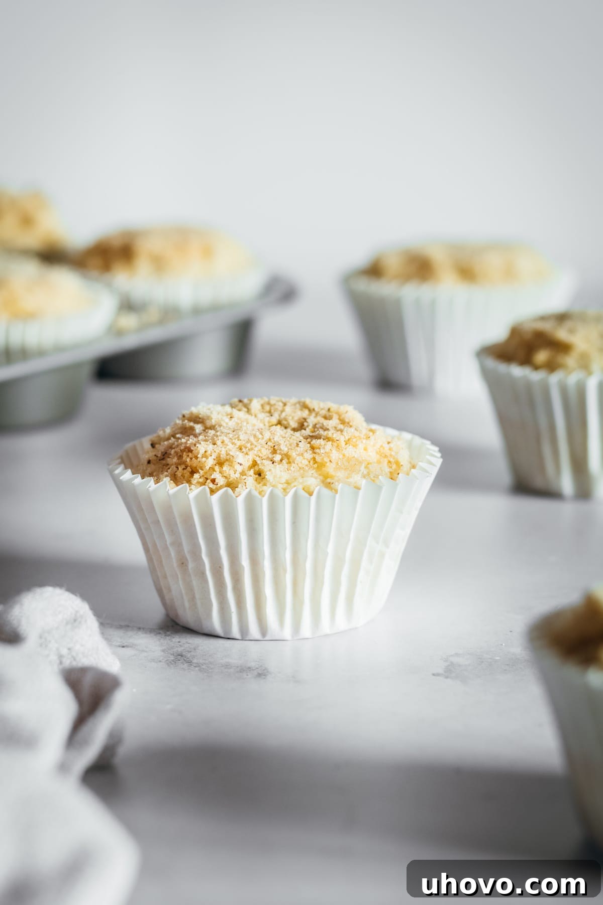 Freshly baked cream cheese muffins arranged on a sleek marble slab, radiating warmth and deliciousness.