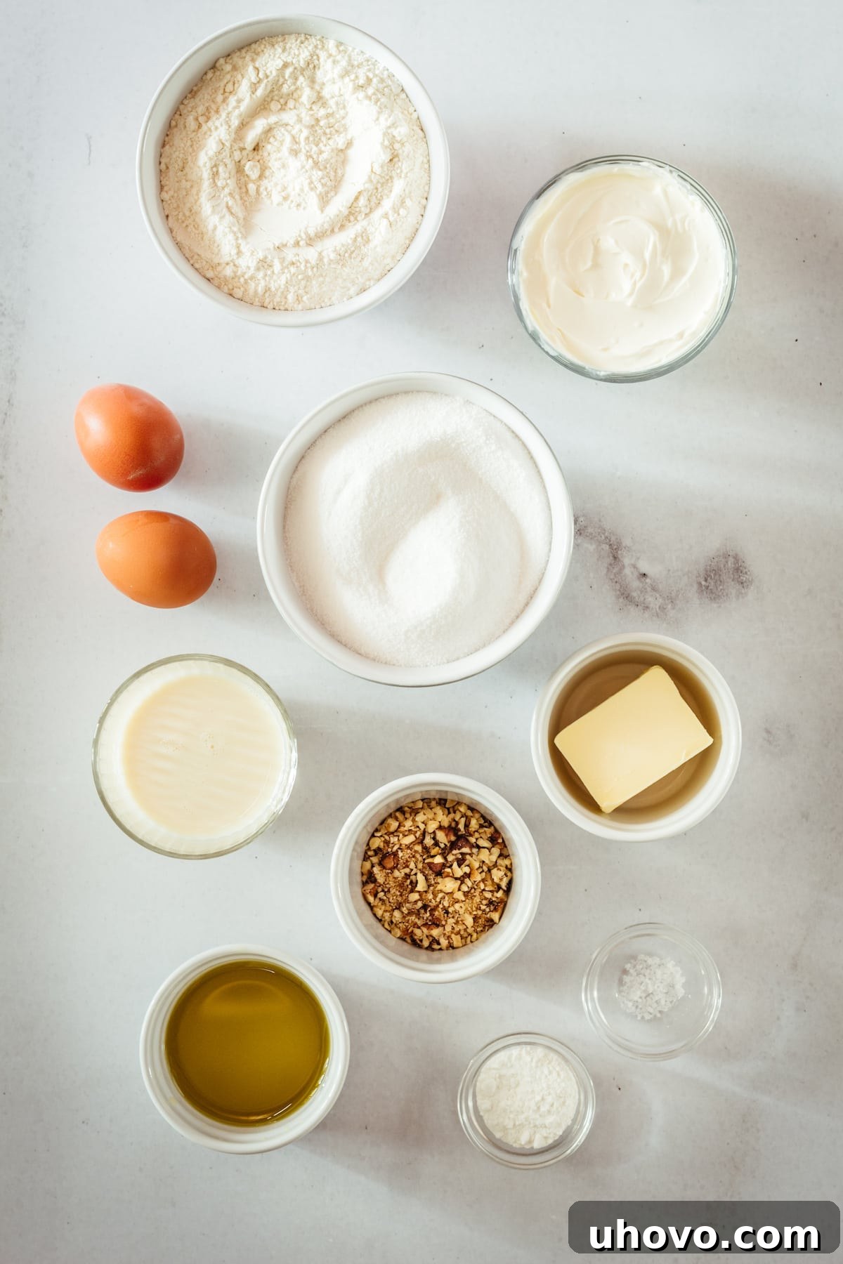 Overhead view of all the cream cheese muffin ingredients neatly arranged on a counter, ready for baking.