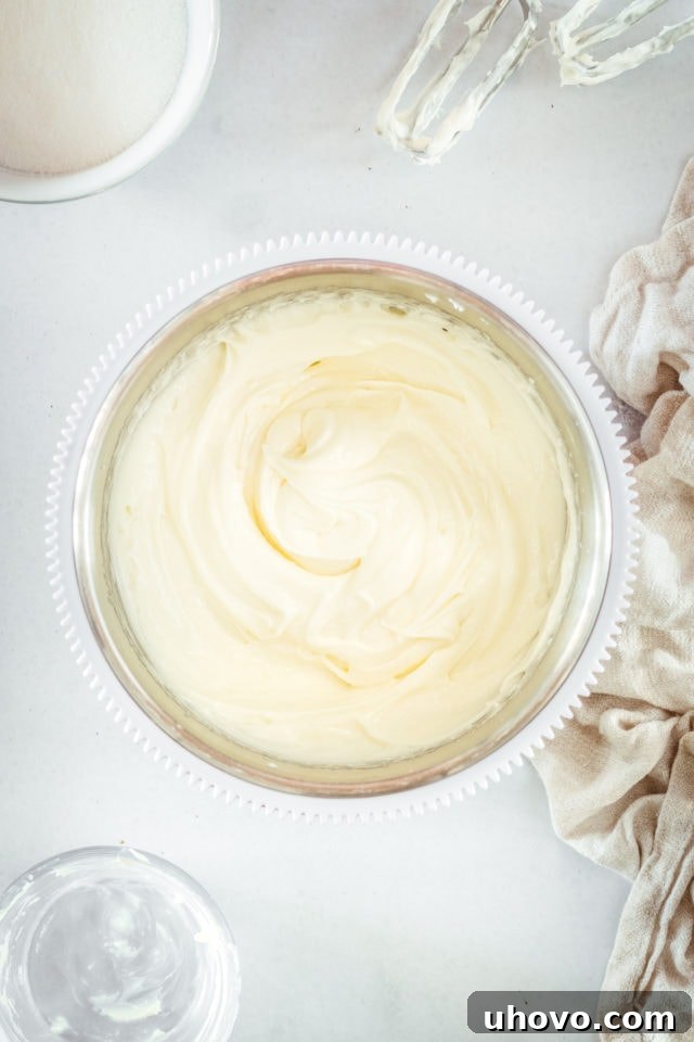 Overhead view of perfectly smooth and creamy sweetened cream cheese mixture in a mixing bowl.