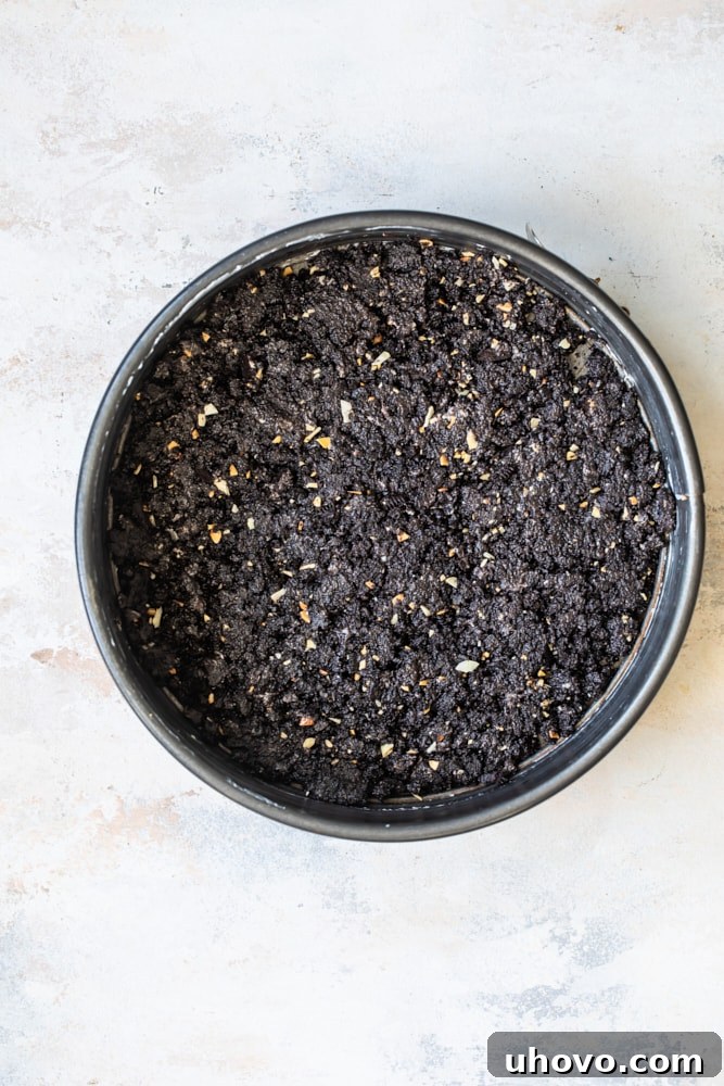 Chocolate Coconut Almond Cheesecake crust, a dark chocolate cookie crumb base, pressed into the bottom of a springform pan.