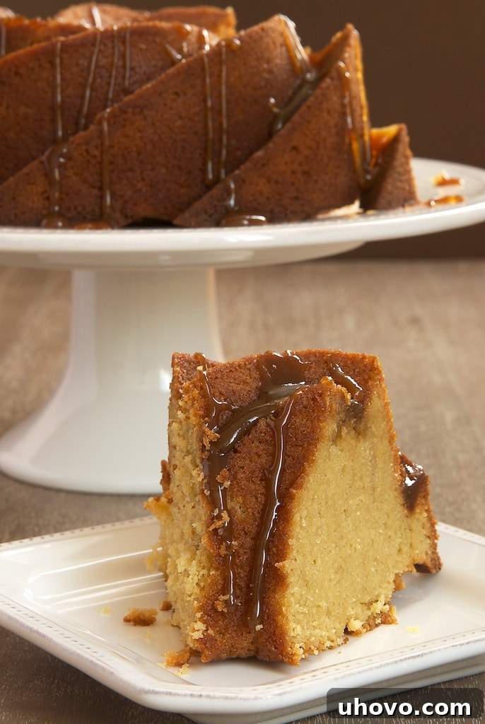 Close-up of a delightful slice of Brown Sugar Bundt Cake, revealing its luscious, moist texture, generously coated with a sticky brown sugar glaze.