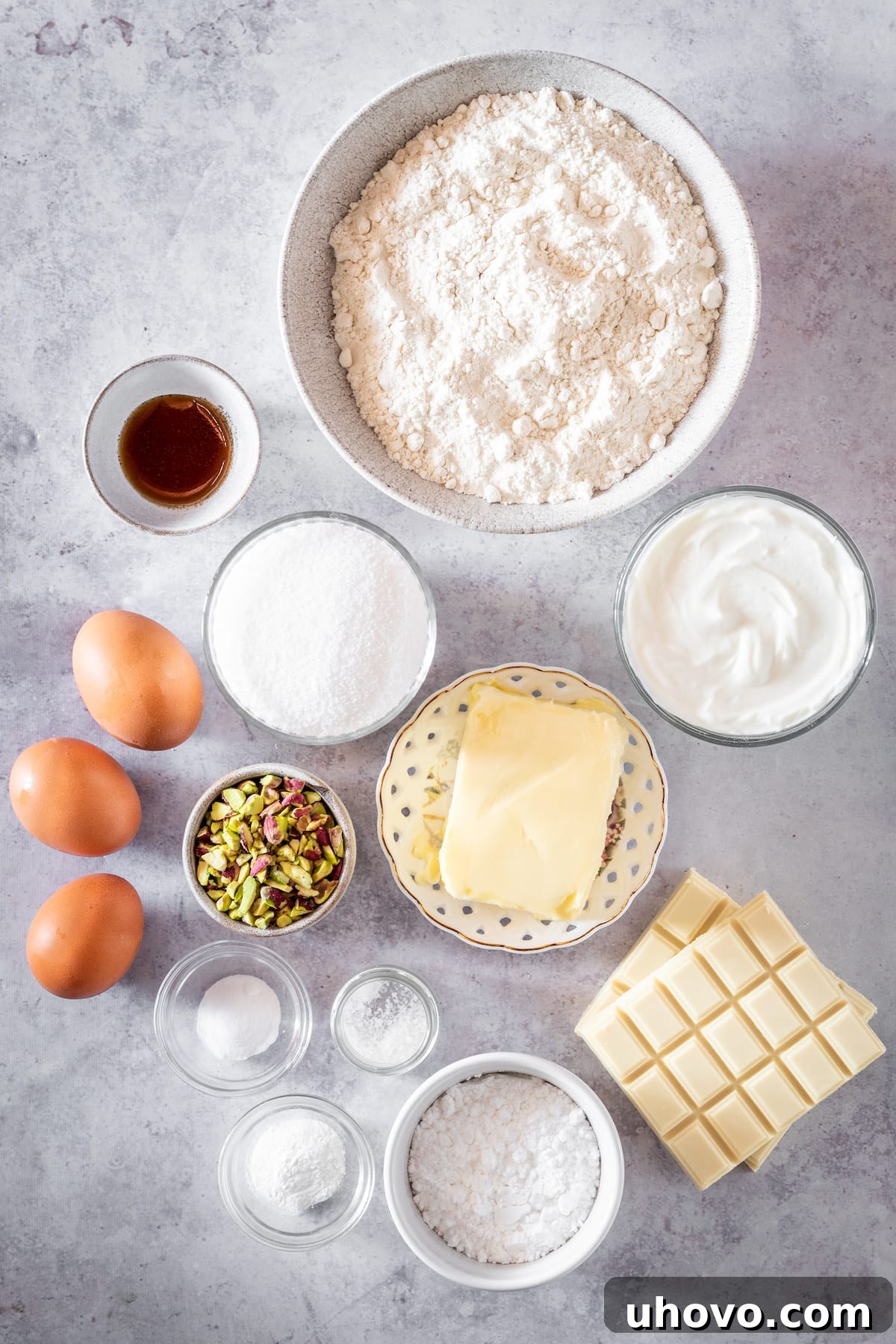 Overhead shot of all the ingredients for Pistachio Cake and White Chocolate Frosting laid out on a white surface.