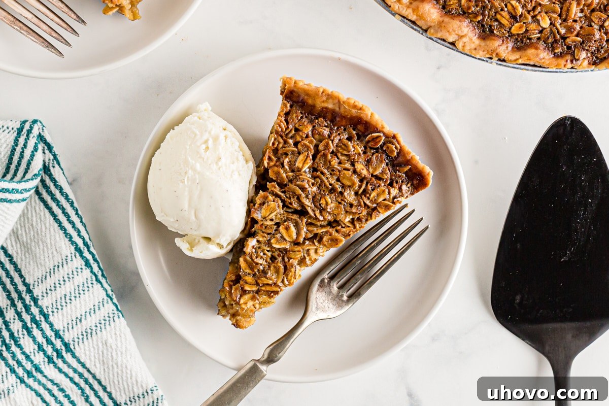 A slice of oatmeal pie generously topped with a scoop of creamy vanilla ice cream, served à la mode.