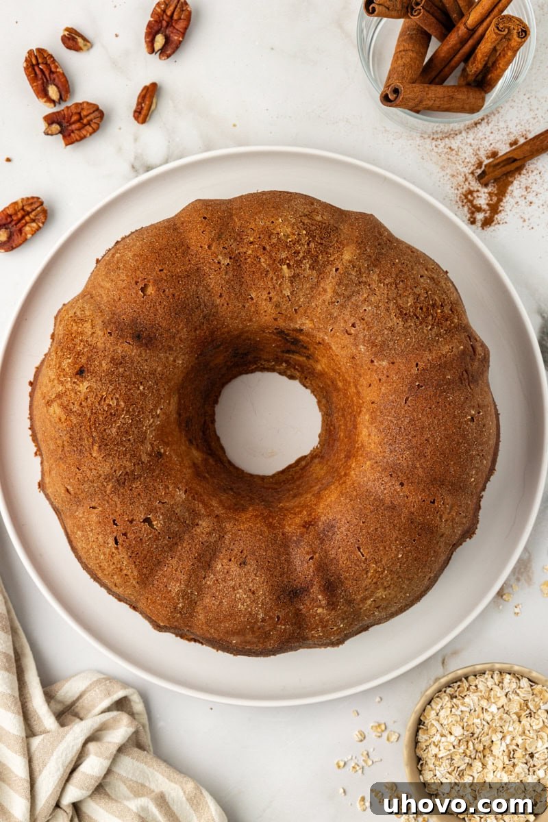 Overhead view of a beautiful, golden brown cinnamon crown cake cooling on a platter