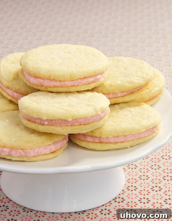 Strawberry-Lemon Sandwich Cookies feature a sweet strawberry filling between soft lemon cookies.