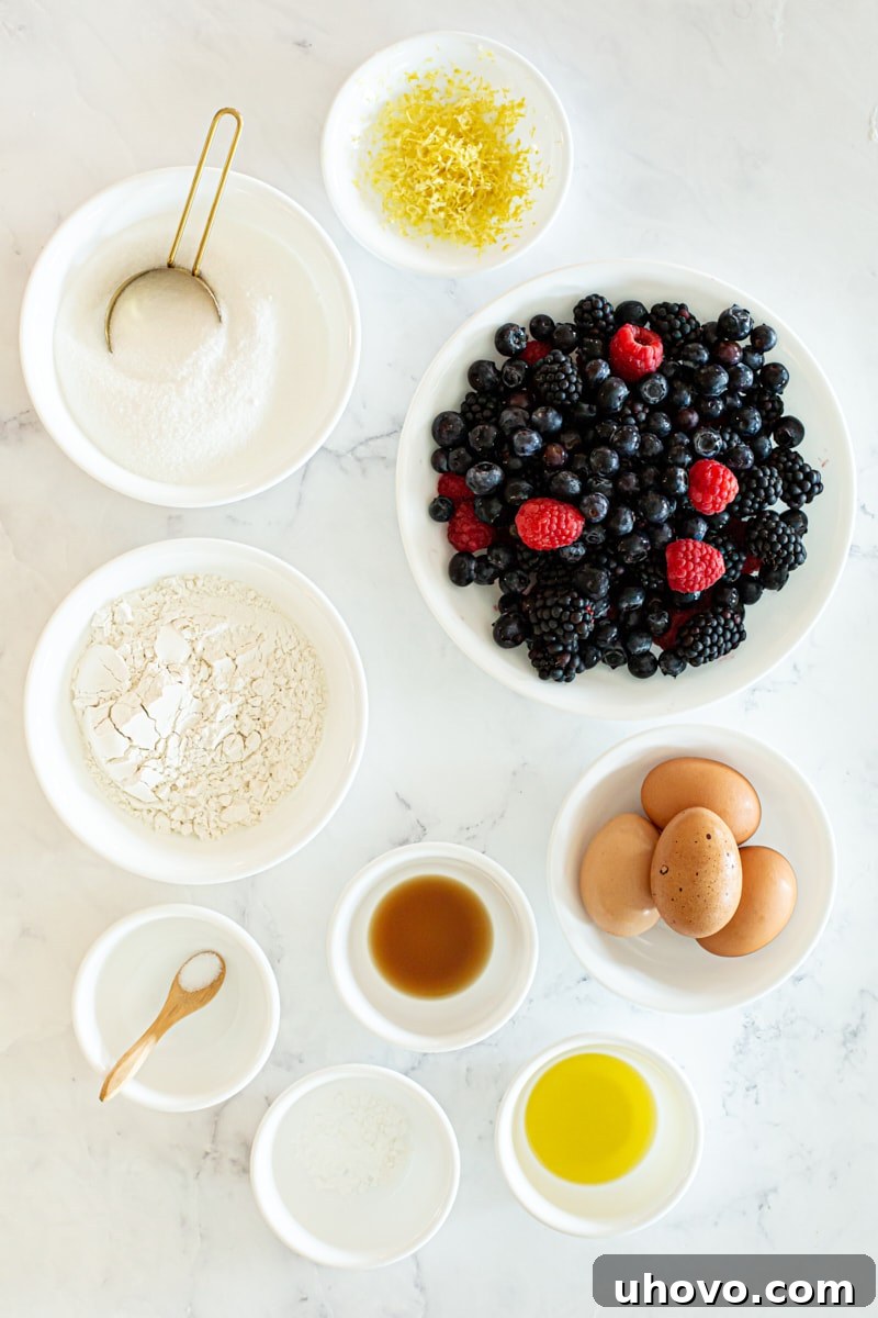 An inviting overhead shot showcasing all the essential ingredients laid out for preparing a delicious berry pudding cake, ready for mixing.