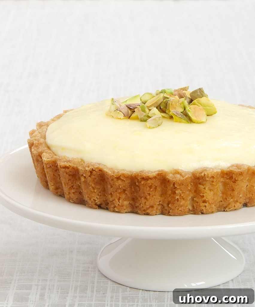 Delicious Lemon Cream Tart on a white pedestal, perfect for summer