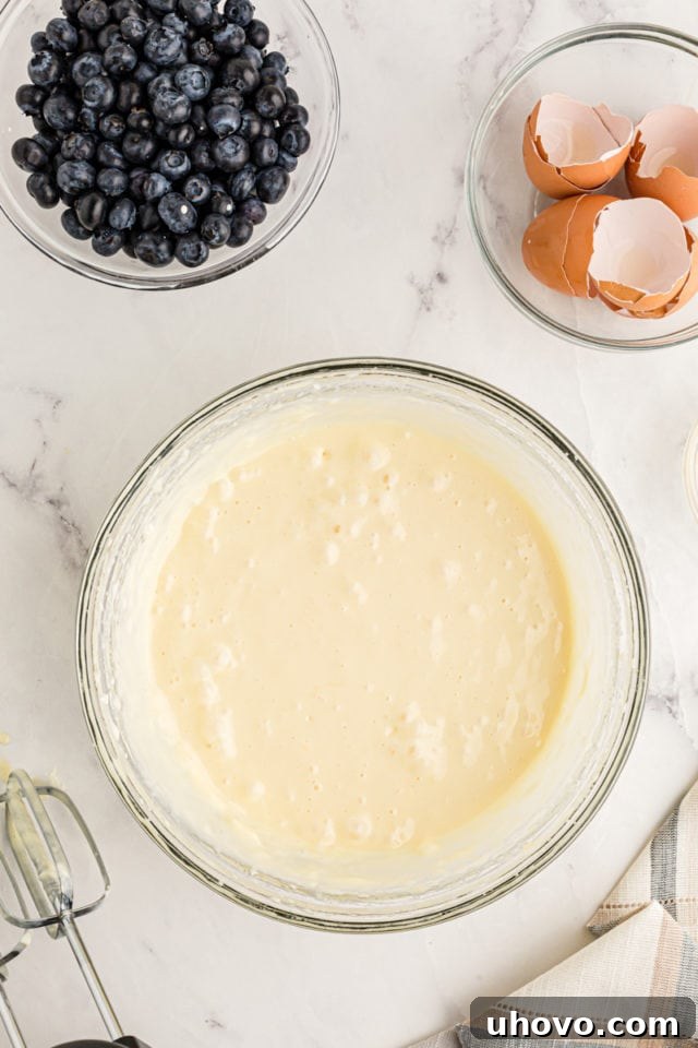 Overhead view of cheesecake mixture in glass bowl