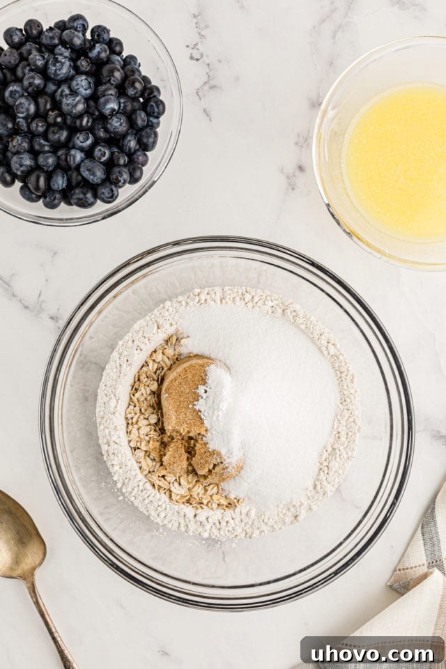 Overhead view of dry ingredients for crust in glass bowl