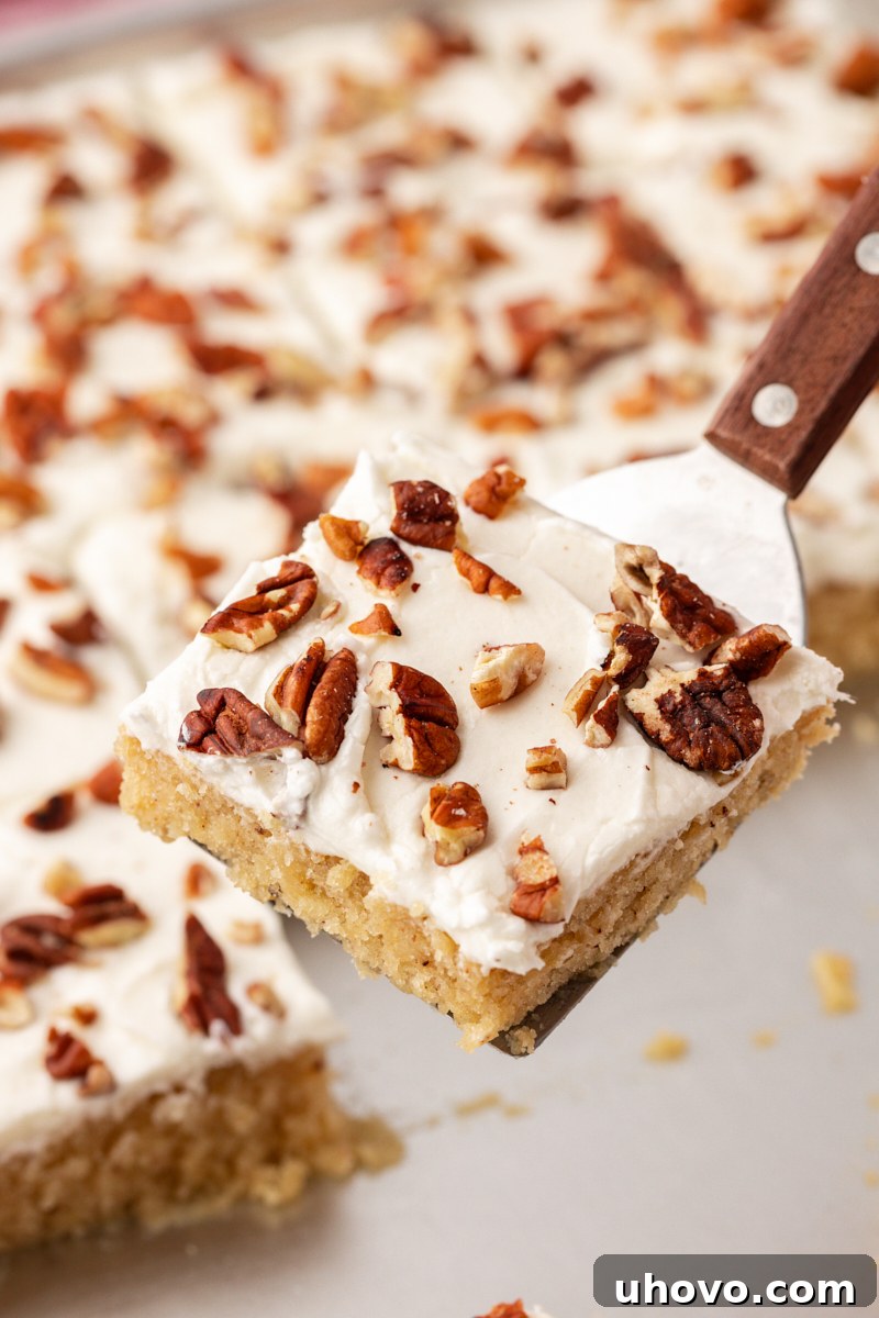 Spatula holding slice of brown butter Texas sheet cake