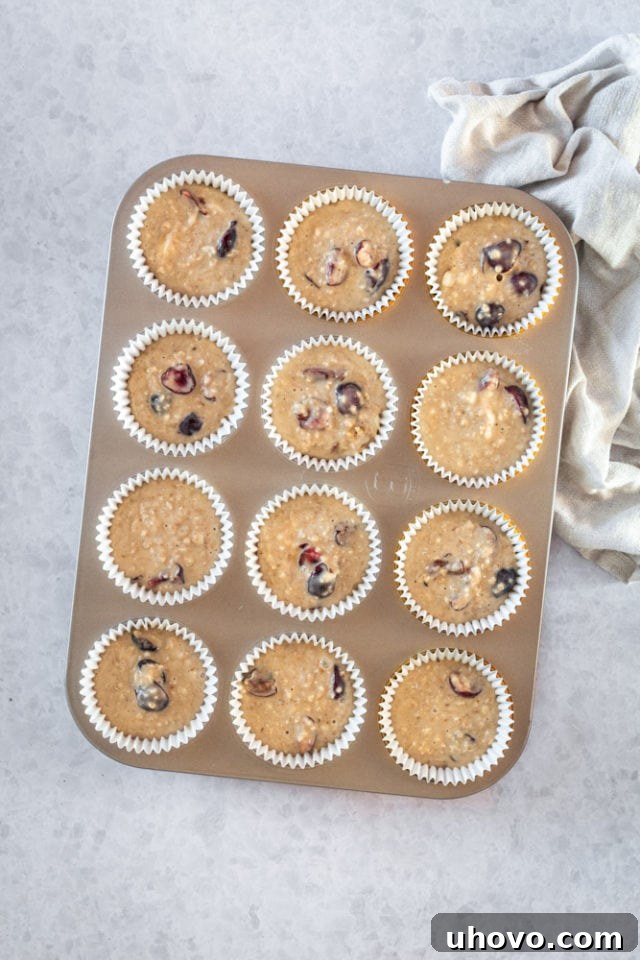 Overhead view of Cherry Cheesecake Muffins prepared in a muffin pan, ready for the oven.